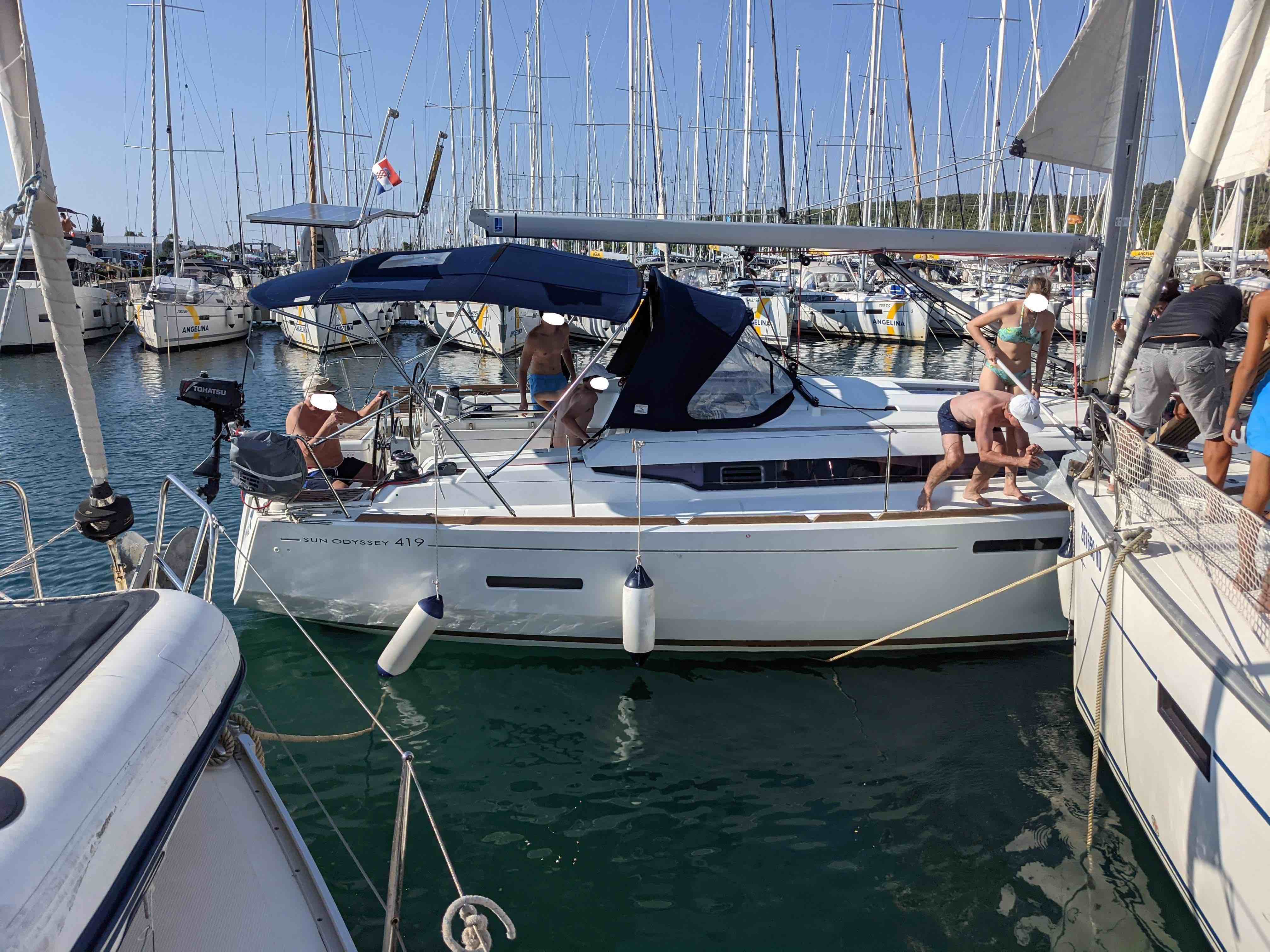 A sailboat hitting another boat in the marina