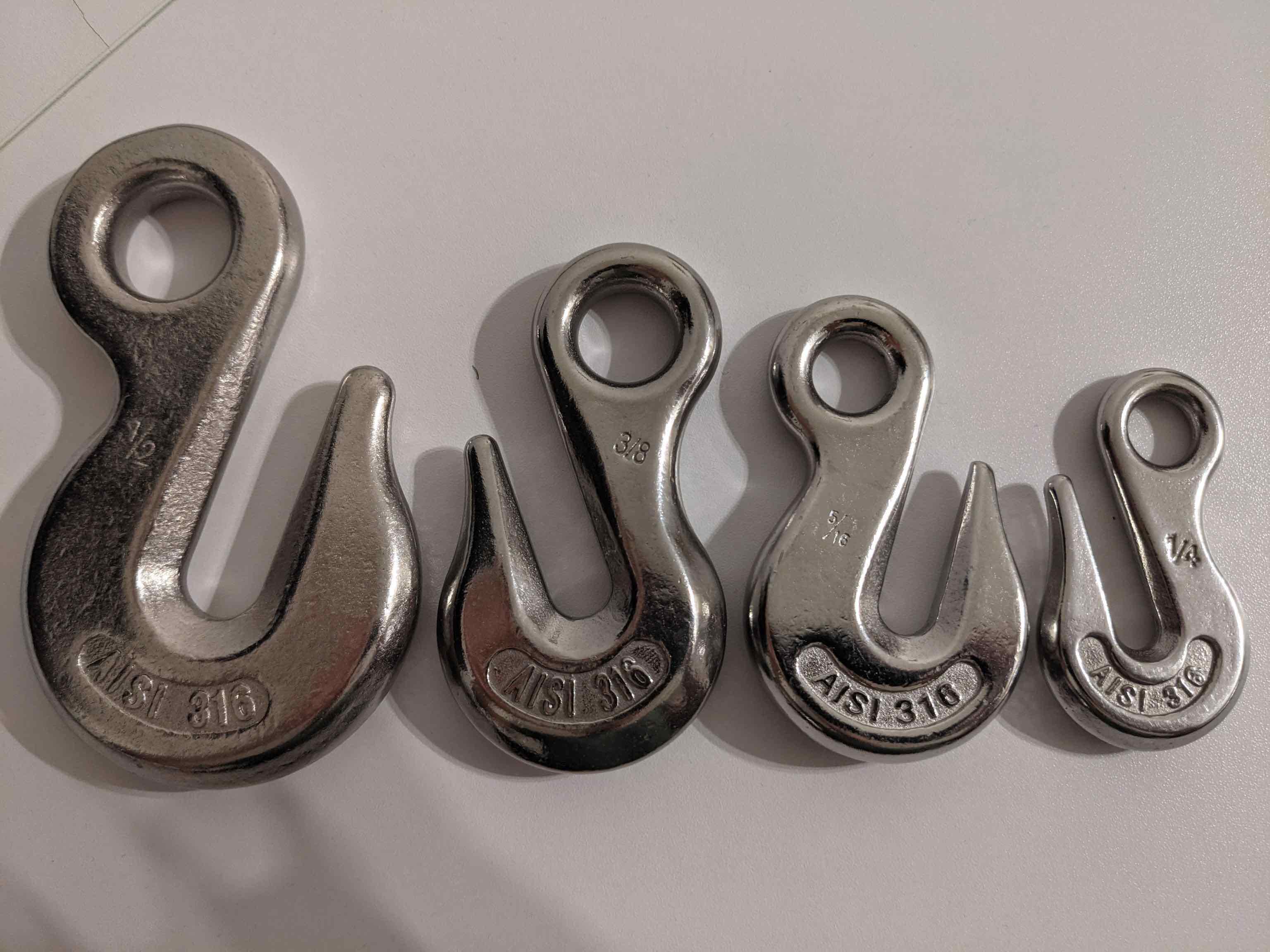 Four boat anchor chain hooks of different sizes